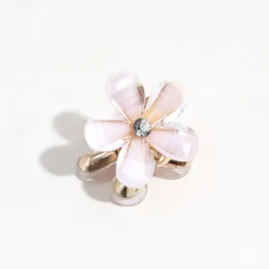 Mini floral hair claw clip with rhinestone center and gold teeth, perfect for sweet styling.