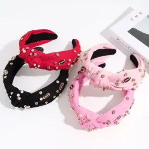 Wide knotted headband with pearls and rhinestones, stylish fabric hair hoop for women and girls.