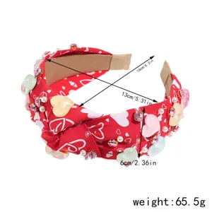 Detailed view of the red heart knot headband, showing dimensions, rhinestones and pearl decor.