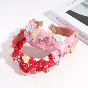 Fashion heart headband detail shot, knotted wide hair hoop with colorful resin rhinestones.