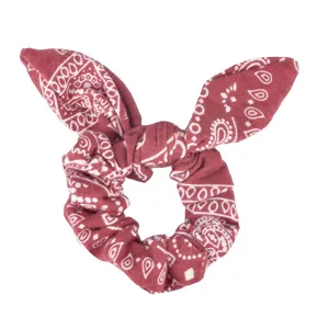 Close-up detail of the red paisley print hair scrunchie with cute bunny ear knot design.