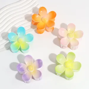 Closeup of the macaron gradient frosted flower hair claw, showing vivid colors and grip.