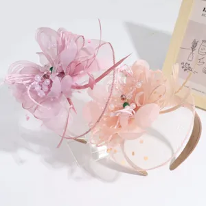 Pink peach feather mesh flower headband elegant fascinator headpiece detail view for party event.