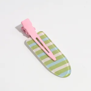 Detailed view of a sweet striped hair clip with pink metal duckbill and colorful stripes.