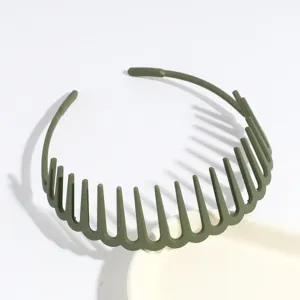 Close-up detail of dark green plastic tooth headband, non-slip hair hoop accessory for daily styling.