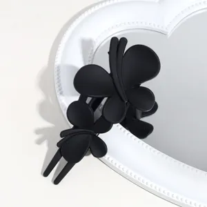 Close-up detail of the matte black butterfly hair claw clip showcasing fine texture and design.