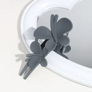 Dark grey matte butterfly hair claw clip detail view, stylish hairpin for elegant hairstyles.