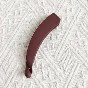 Detail view of the matte banana hair clip, stylish hair accessory for daily wear.