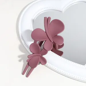 Close-up detail of a matte purple butterfly hair claw clip, perfect for elegant hairstyles.