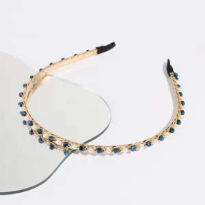 Detail shot of Korean style thin crystal pearl headband, gold chain design with blue rhinestones.