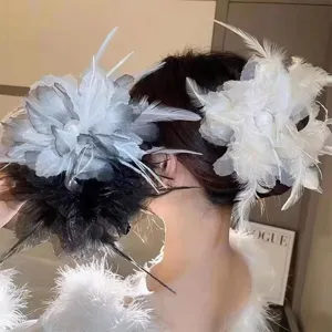 Feather flower hair claw clip detail, elegant white and grey hair accessory for women.