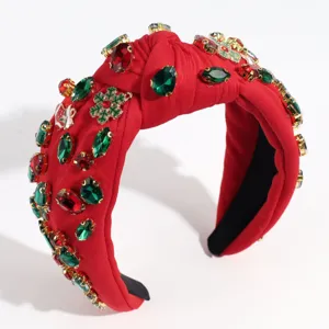 Closeup detail of Christmas red knotted headband with sparkling rhinestones and crystal snow.