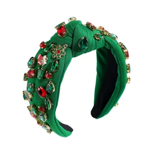 Christmas green knotted headband with colorful rhinestones and festive holiday charms.