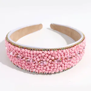 Close up of the wide pink beaded headband with sparkling rhinestones and colorful gemstone accents.