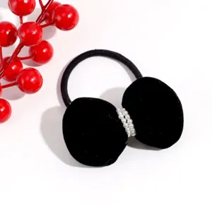 Cute black velvet hair tie with pearl details, elegant fuzzy design for winter styles.