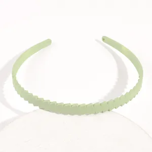 Bellissimo cerchietto per capelli in plastica verde chiaro con trama a zig-zag dettaglio.