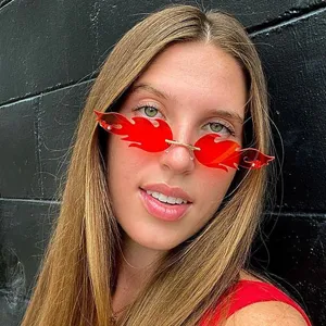 Close-up detail of trendy red flame rimless sunglasses worn by model, stylish fashion street style.