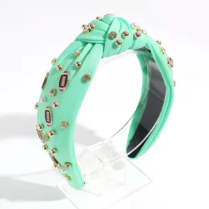 Mint green knotted headband with pearls rhinestones and football charms detail view
