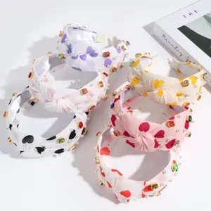 Cute heart knotted headband with pearls and crystals, perfect fashion hair accessory.