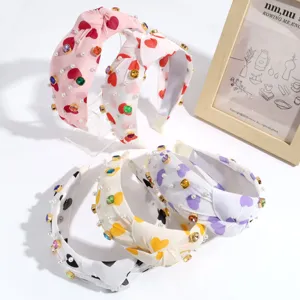 Fashion knotted headband with heart print, pearls, and colorful rhinestones for daily wear.