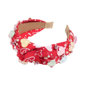 Red knotted headband with heart patterns, resin hearts and rhinestones for women girls.