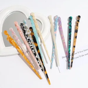 Detailed shot of assorted acetate hair sticks with colorful patterns and elegant spiral design.