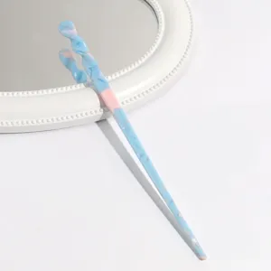 Close-up view of a blue and pink swirled acetate hairpin showcasing its elegant texture.