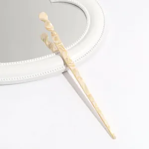 Elegant beige acetate hair stick with marble pattern, minimalist design for updos.
