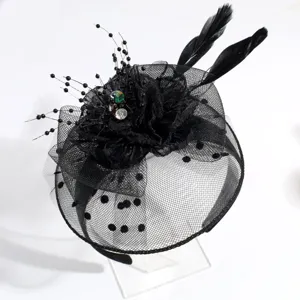 Detail shot of elegant black mesh fascinator headband with feathers and crystal accents.