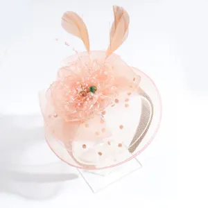 Elegant peach fascinator headband with mesh, flowers, feathers and pearls for party events.