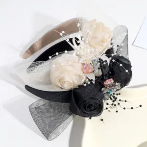 Exquisite close-up detail of elegant banquet floral headband with roses, mesh veil and pearls.