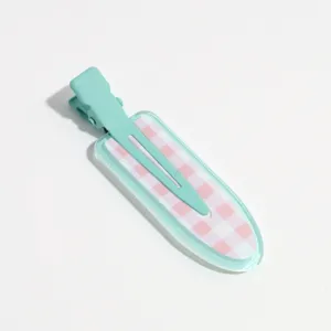 Mint green duckbill hair clip close-up showing cute pink and white gingham pattern detail.