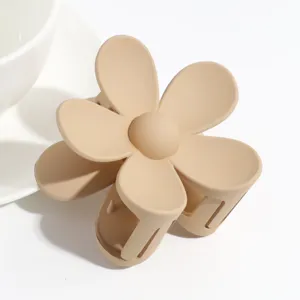 Matte flower hair claw clip in nude beige color, cute aesthetic hair accessory for women.