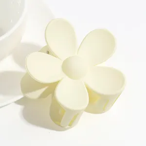 Cute pastel yellow matte flower hair claw clip for women and girls, sweet styling hair accessory.