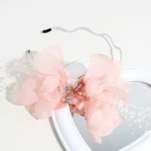 Pink flower headband detail, elegant chiffon petals with sparkling crystal beads and silver hair hoop.