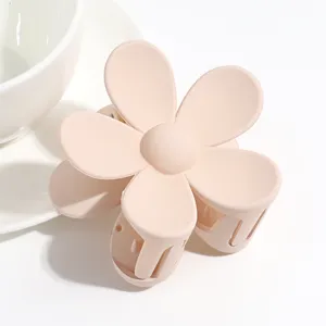 Matte pink flower hair claw clip close up, cute floral hair accessory for daily styling.