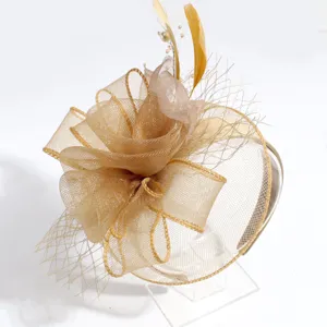 Close-up detail of the elegant gold court-style mesh fascinator headband with feathers and pearls.