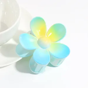 Detail view of a cute gradient blue and yellow flower hair claw clip, sweet daily hair accessory.