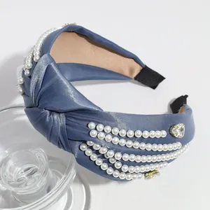 Blue satin headband with pearls and rhinestones, elegant knotted hair accessory for women.