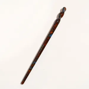 Elegant tortoise shell acetate hair stick with twisted top design for stylish daily hair buns.
