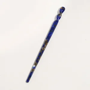 Detailed view of blue tortoiseshell acetate hair stick with unique twisted top and glossy finish.