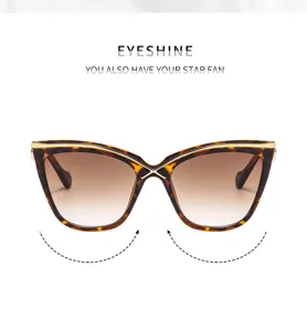 Gafas de sol cat-eye de moda para mujer con montura carey y puente metálico cruzado.