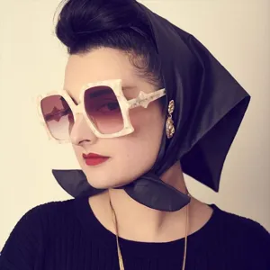 Close-up detail of avant-garde bat shaped oversized sunglasses with unique geometric frames.
