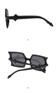 Detailed view of black bat-shaped stylish sunglasses, showing side and back design lines.