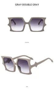 Detailed view of fashionable irregular bat-shaped sunglasses with stylish gradient grey lenses.