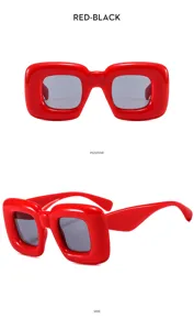 Detail view of bold red bubble chunky square sunglasses, stylish and unique streetwear eyewear.