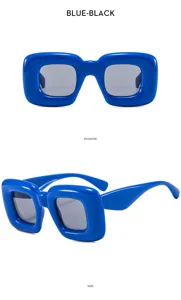Detailed view of trendy blue chunky square sunglasses, showing thick puffy frame and dark lenses.