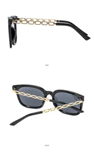 Occhiali da sole neri chic con aste a catena dorata, montatura oversize da donna.