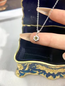 Detailed shot of a classic six-prong green gemstone necklace with s925 silver chain.