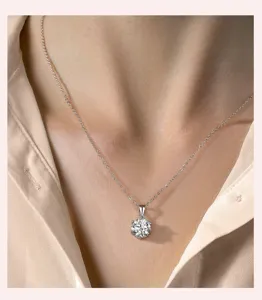 Classic six-prong moissanite pendant necklace, delicate clavicle chain detail shot.